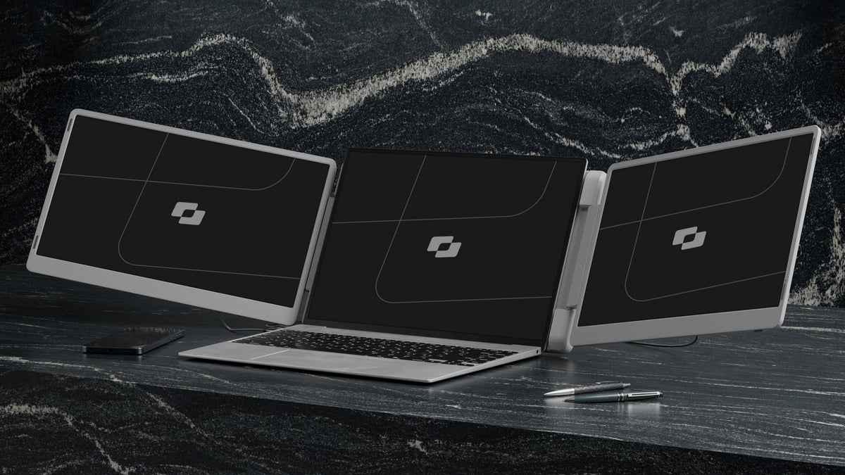 Flip 15.6″ — Screenmate Flip unfolded with two side screens next to a laptop on a dark desk