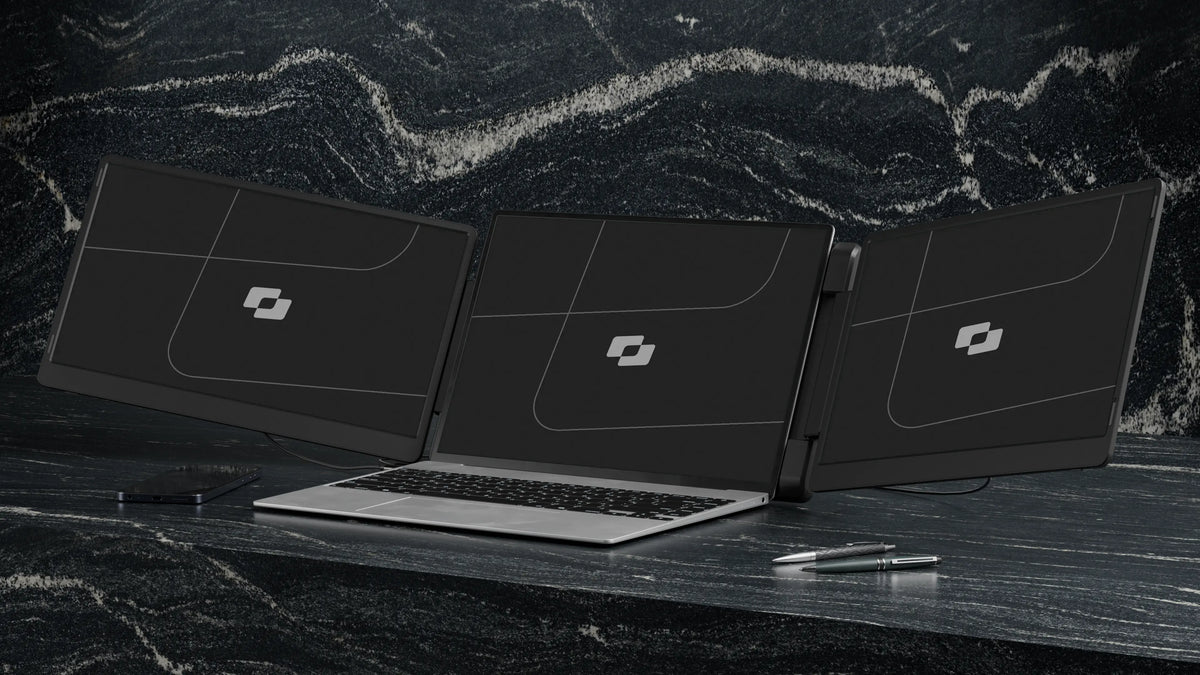 Flip 15.6″ — Screenmate Flip unfolded with two side screens next to a laptop on a dark desk