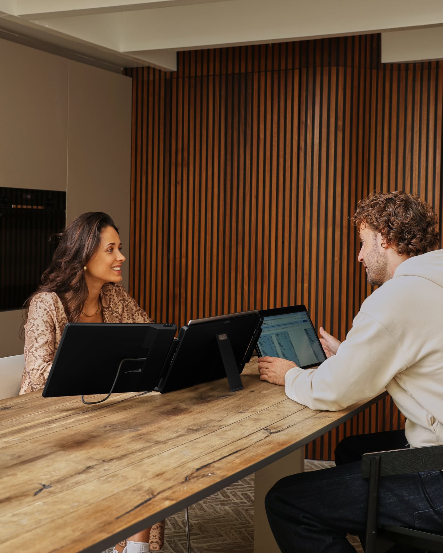 Two people at a table with the black Screenmate Flip